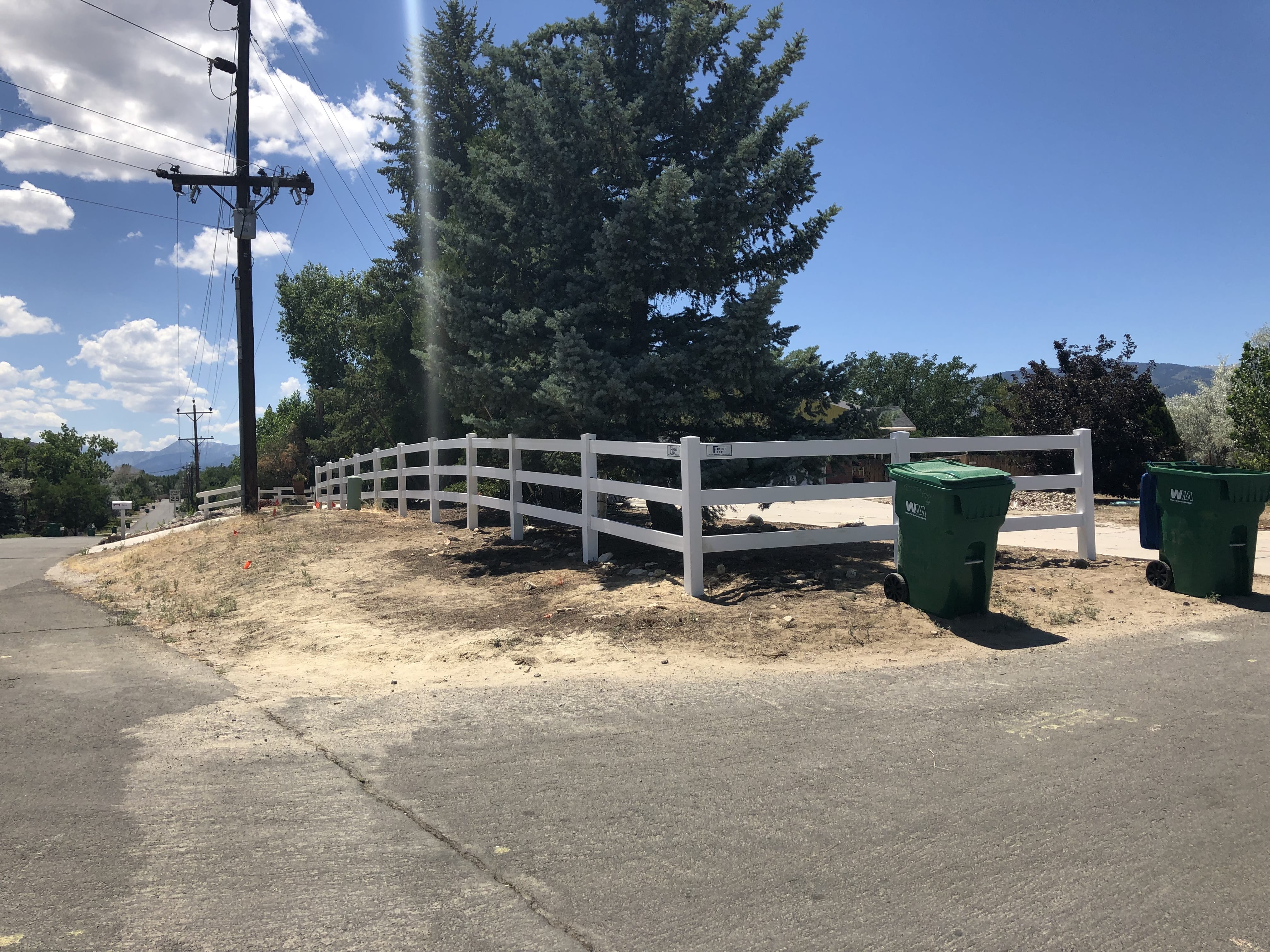 picture of white wooden ranch fencing around a farm