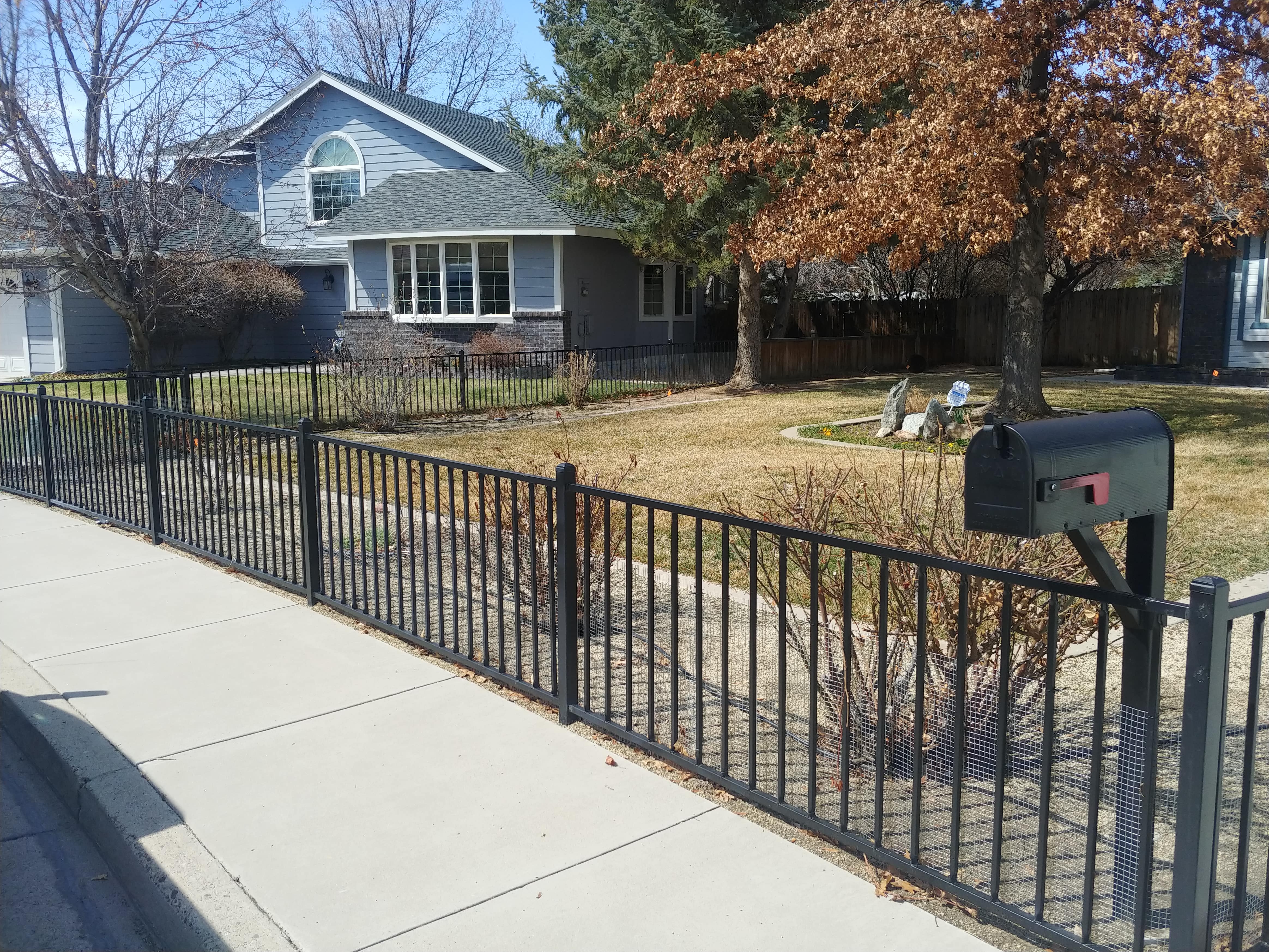 picture of black ornamental fencing around a house